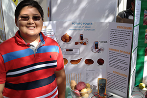 Boy with Potato Science Fair Project