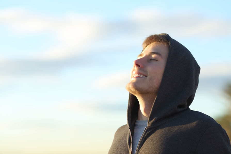 Young Man Taking a Breath of Fresh Air Smiling